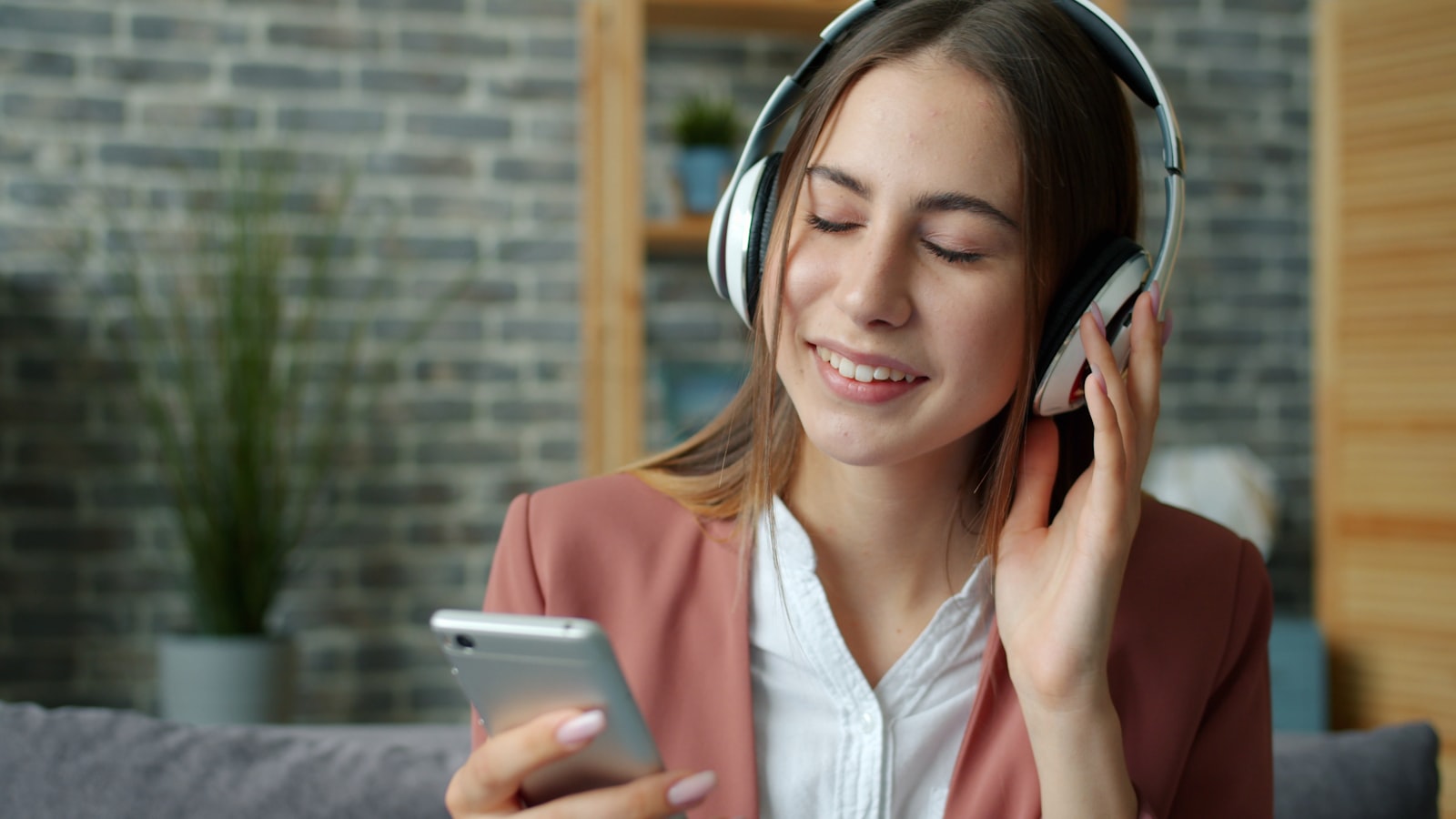 A person following along on their phone with headphones